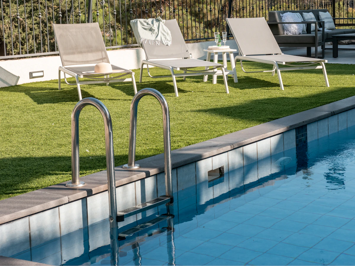 Lush artificial grass installation surrounding a backyard pool in Tucson AZ
